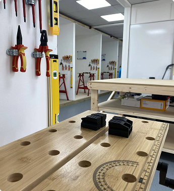 Electrical training room with tools mounted on the wall and components on a workbench