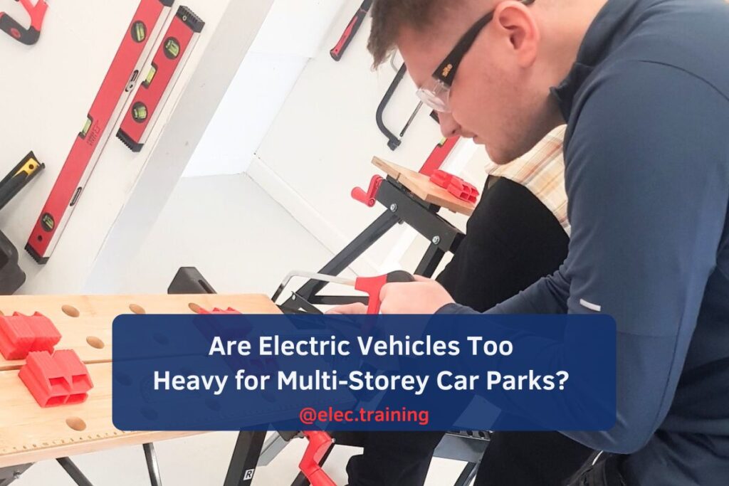 Trainee cutting trunking with a saw as part of practical session